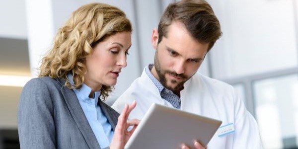 physician and business person talking