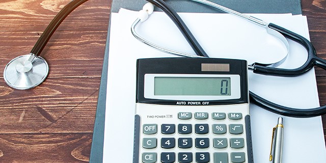 image of a calculator and stethoscope